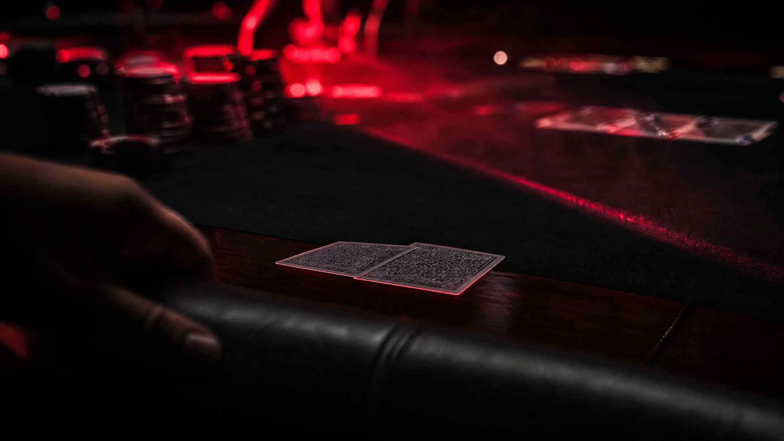 Poker player executing a bluff by pushing chips forward at a felt table